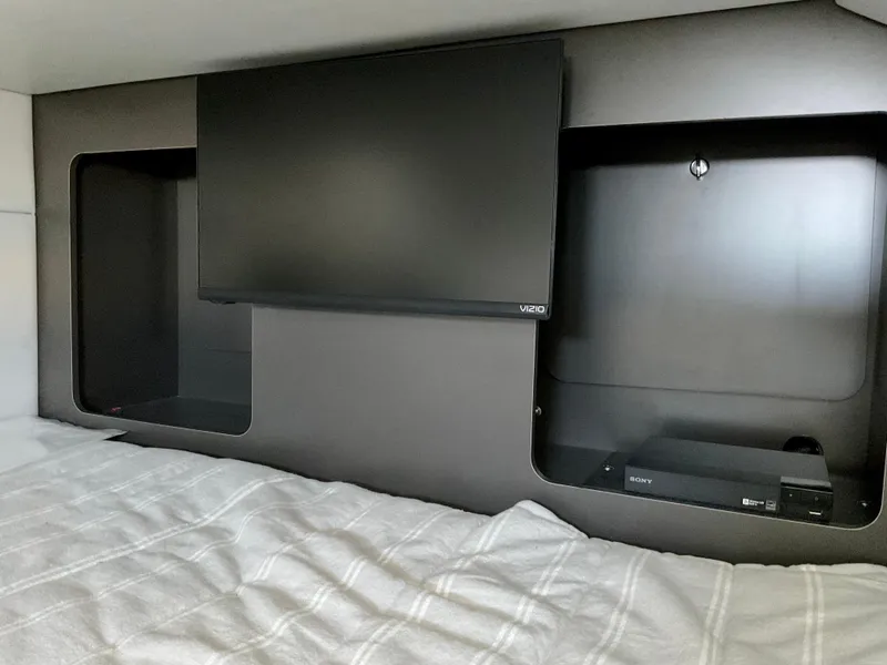 Slide: The Image of 2022 Formula 350 Crossover Bowrider I/O cabin with TV and storage compartments. - 27