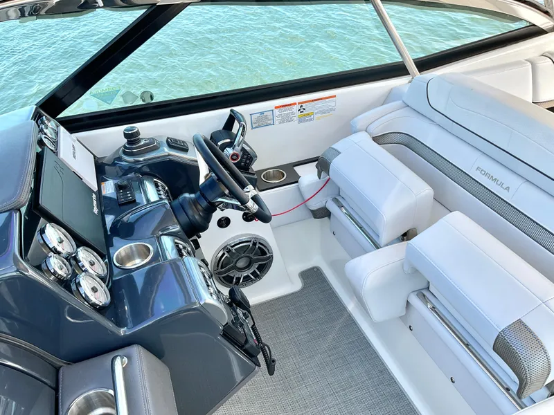 Slide: The Image of 2022 Formula 350 Crossover Bowrider I/O interior with sleek dashboard and plush seating. - 28