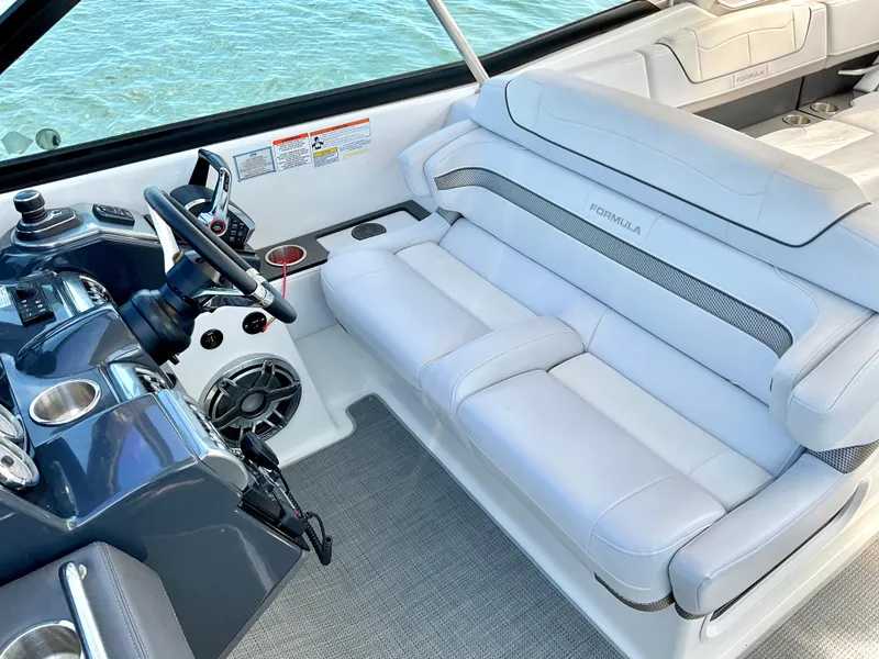 Slide: The Image of 2022 Formula 350 Crossover Bowrider I/O interior with plush seating and modern dashboard. - 29