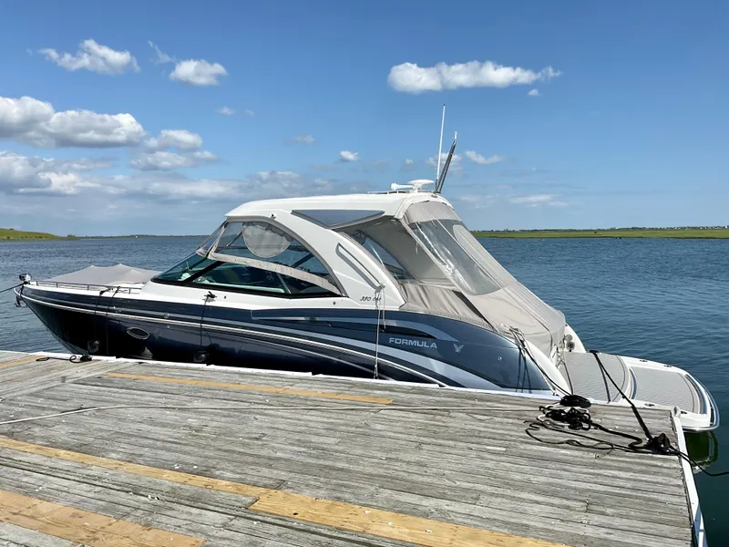 Slide: The Image of 2022 Formula 350 Crossover Bowrider I/O docked on a sunny day. - 3