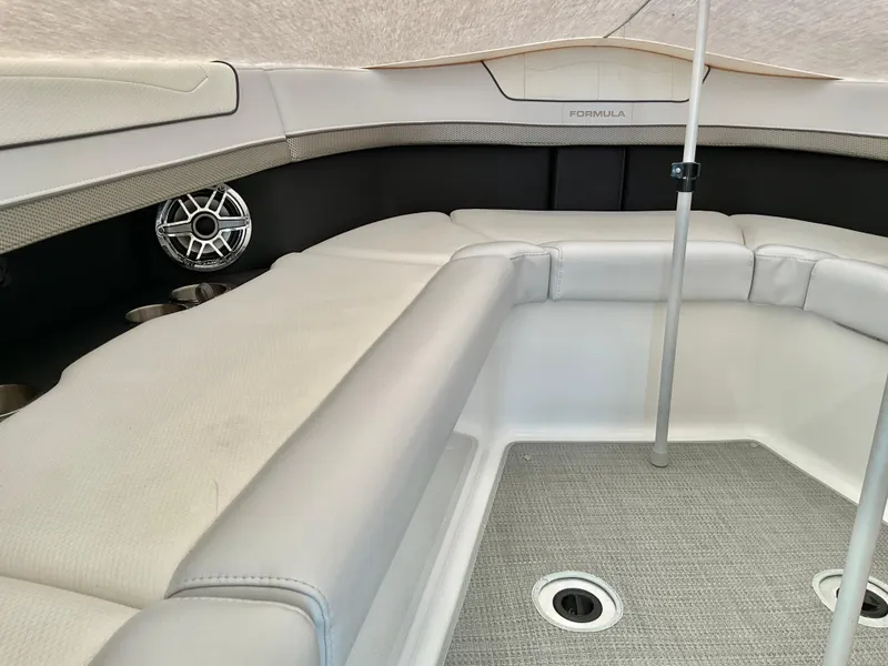 Slide: The Image of 2022 Formula 350 Crossover Bowrider I/O interior with cushioned seating and speaker. - 38