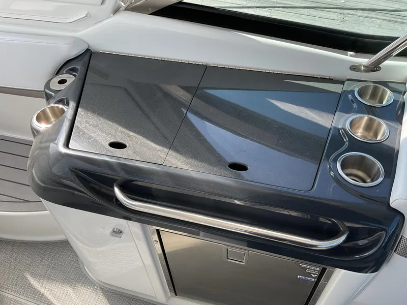 Slide: The Image of 2022 Formula 350 Crossover Bowrider I/O boat kitchenette with sleek countertop and cup holders. - 42