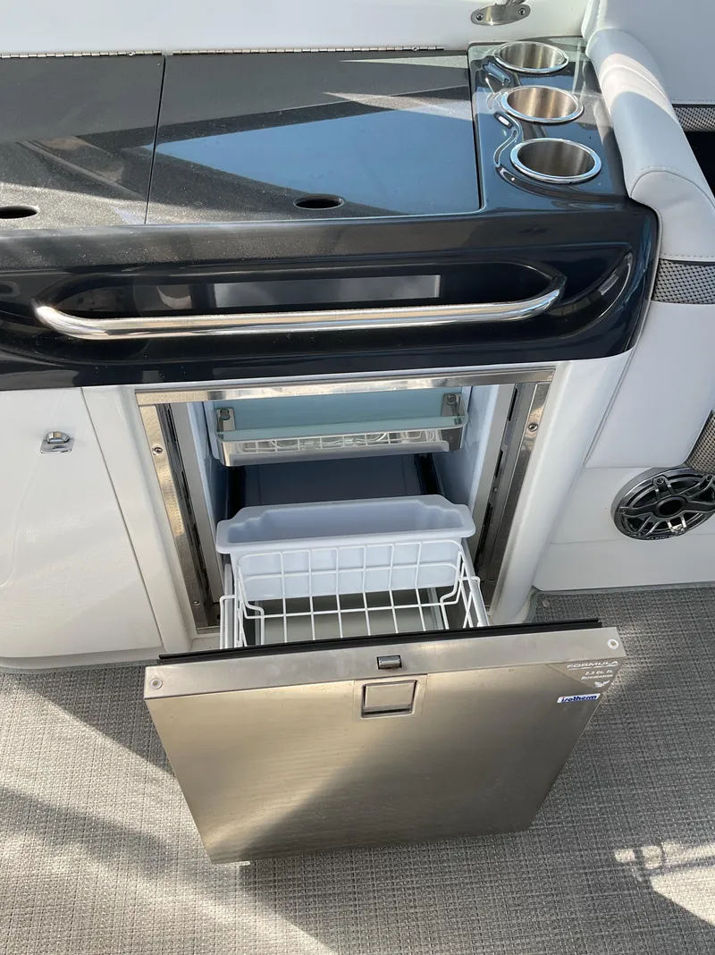 Slide: The Image of 2022 Formula 350 Crossover Bowrider I/O with open stainless steel refrigerator. - 43