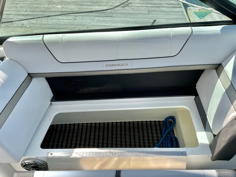Slide: The Image of 2022 Formula 350 Crossover Bowrider I/O interior storage compartment with blue rope. - 45