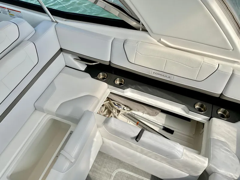 Slide: The Image of 2022 Formula 350 Crossover Bowrider I/O interior with white seating and storage compartments. - 47