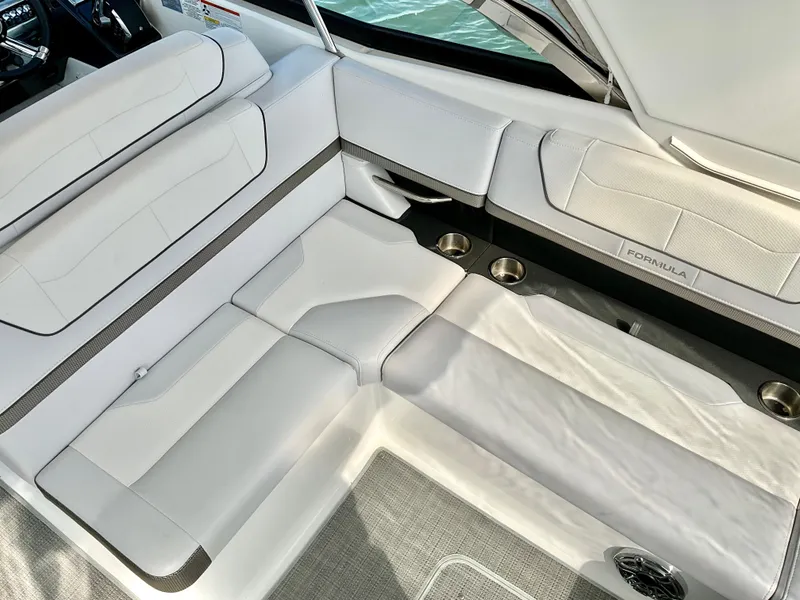Slide: The Image of 2022 Formula 350 Crossover Bowrider I/O interior with white seating and cup holders. - 48