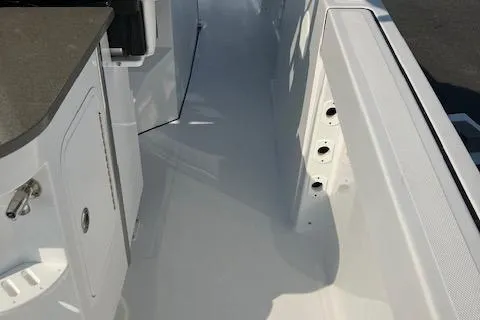 Slide: The Image of 2025 Wellcraft 352 Fisherman boat interior, featuring sleek white deck and storage compartments. - 13
