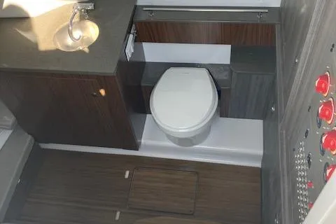 Slide: The Image of 2025 Wellcraft 352 Fisherman boat bathroom with modern fixtures and wood accents. - 16