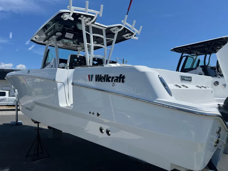 Slide: The Image of 2025 Wellcraft 352 Fisherman boat displayed outdoors under clear blue sky. - 2