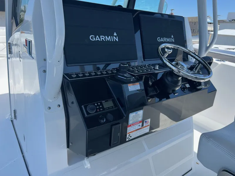 Slide: The Image of 2025 Wellcraft 352 Fisherman boat console with Garmin navigation displays. - 21