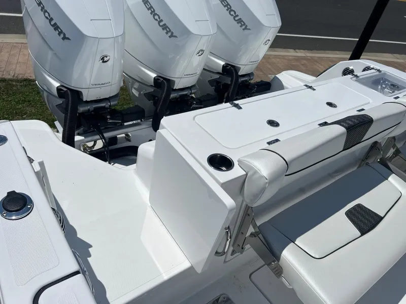 Slide: The Image of 2025 Wellcraft 352 Fisherman boat with triple Mercury engines, white seating, and deck. - 29