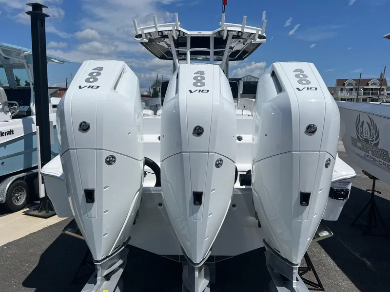 Slide: The Image of 2025 Wellcraft 352 Fisherman with triple 400 V10 engines, docked under a clear sky. - 3