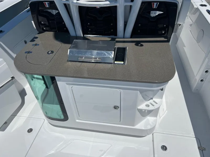 Slide: The Image of 2025 Wellcraft 352 Fisherman boat interior with sleek countertop and storage compartments. - 31