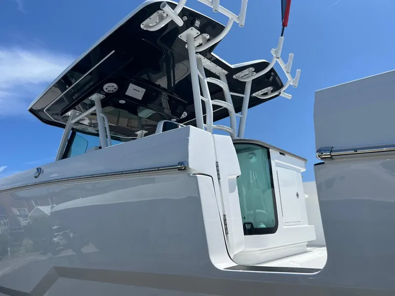 Slide: The Image of 2025 Wellcraft 352 Fisherman boat, sleek design, white exterior, blue sky background. - 33