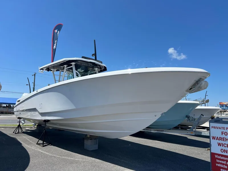 Slide: The Image of 2025 Wellcraft 352 Fisherman boat displayed outdoors under clear blue sky. - 35