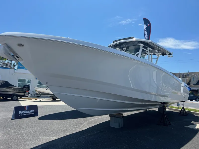 Slide: The Image of 2025 Wellcraft 352 Fisherman boat displayed outdoors under clear blue sky. - 5