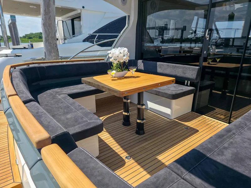 Slide: The Image of Luxurious seating area on 2026 Marex 440 yacht with wooden table and elegant decor. - 14
