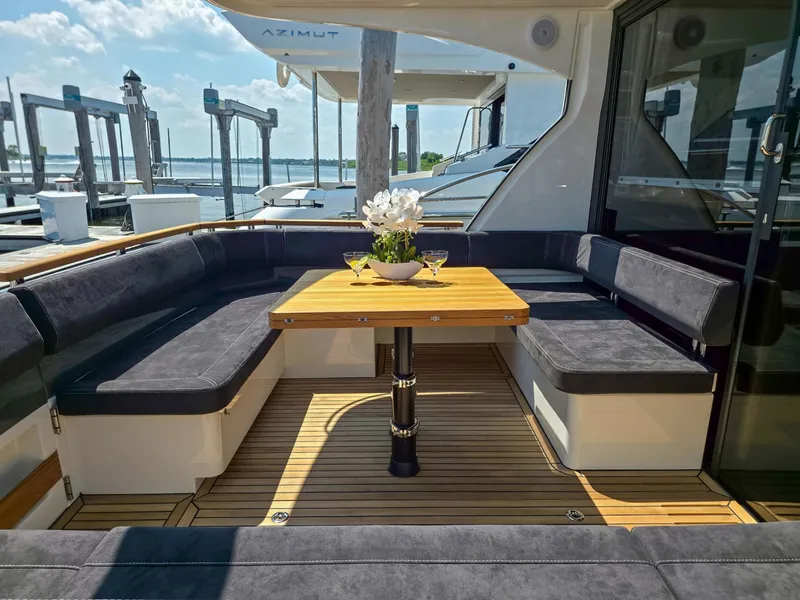 Slide: The Image of Luxurious seating area on 2026 Marex 440 yacht with wooden table and elegant decor. - 16