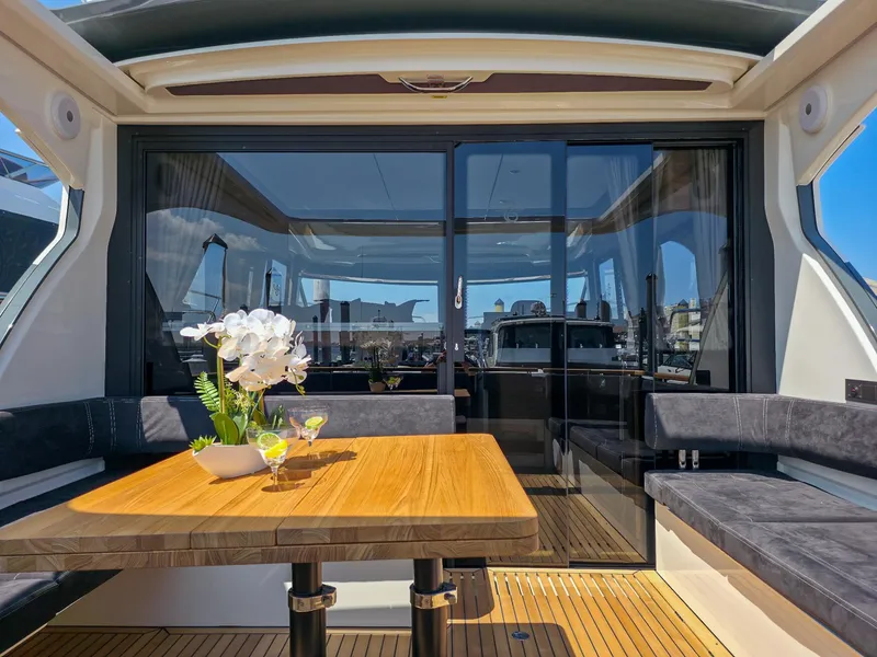 Slide: The Image of Luxurious Marex 440 yacht interior, featuring elegant seating and a wooden table with floral decor. - 17