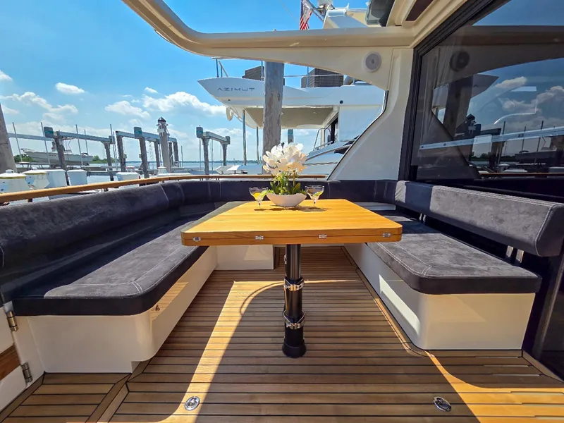 Slide: The Image of Luxurious seating area on 2026 Marex 440 yacht with wooden table and elegant decor. - 21