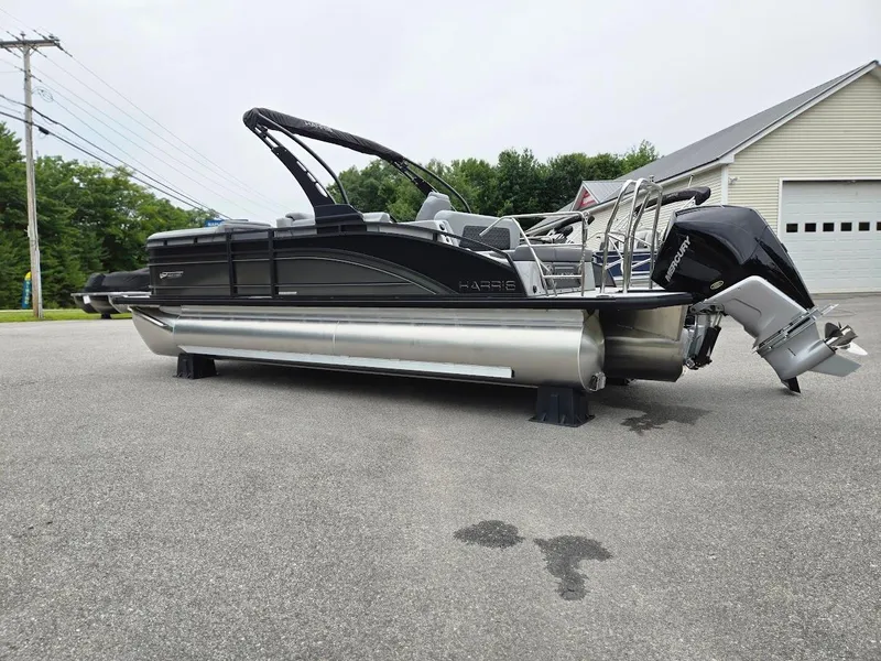 Slide: The Image of 2025 Harris Solstice 230 pontoon boat with sleek design and powerful outboard motor. - 3