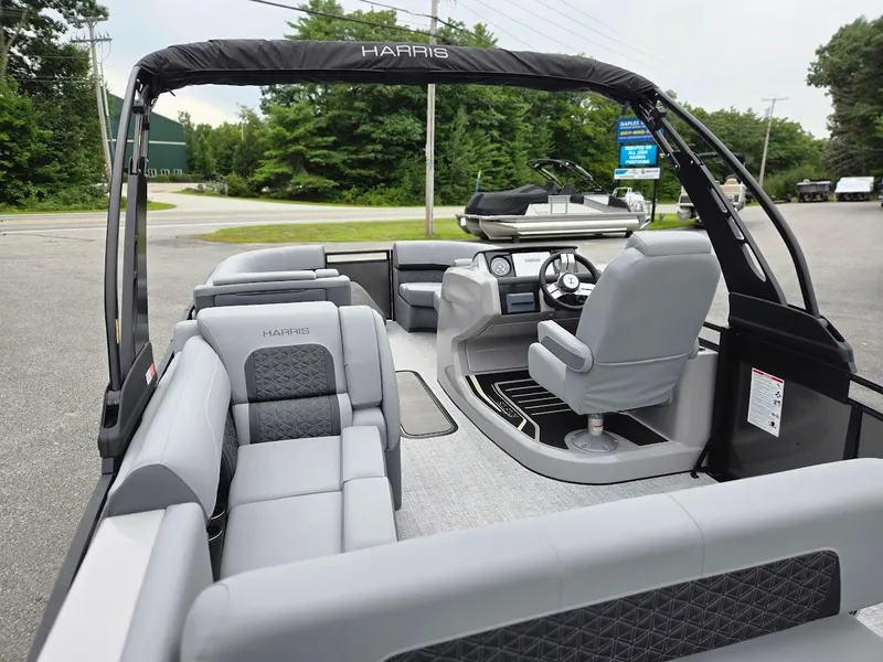 Slide: The Image of 2025 Harris Solstice 230 pontoon boat interior with modern seating and steering console. - 6
