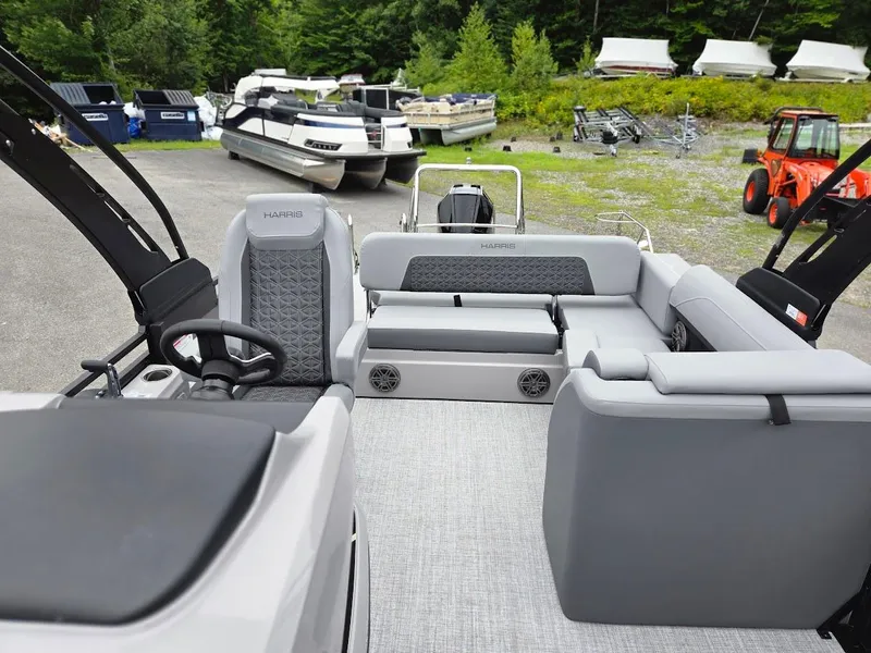 Slide: The Image of 2025 Harris Solstice 230 pontoon boat interior with gray seating and steering wheel. - 8