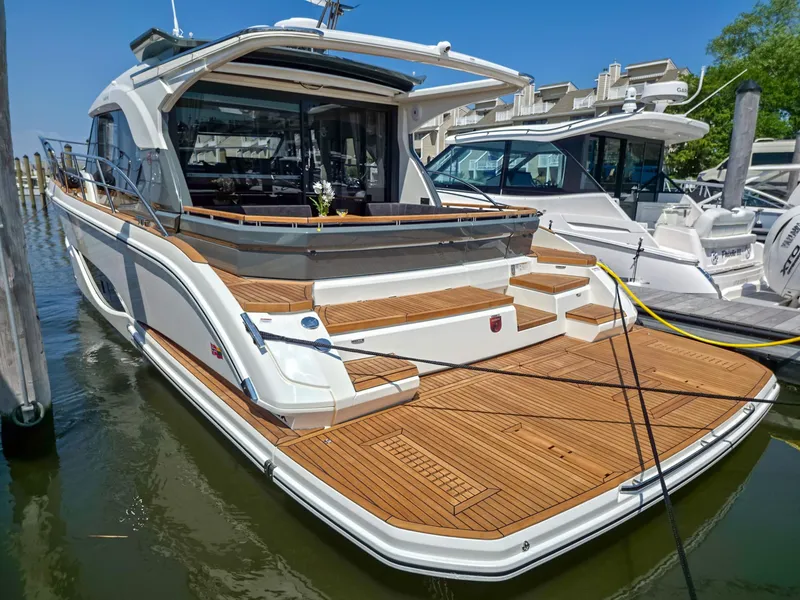 Slide: The Image of Luxury Marex 440 yacht, 2026 model, docked with elegant wooden deck. - 10
