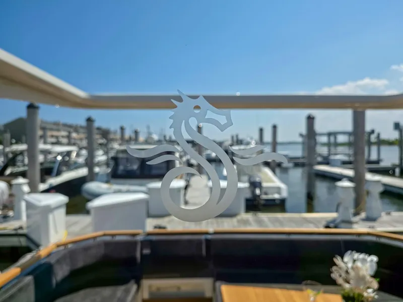 Slide: The Image of Marex 440 yacht interior with marina view, featuring a seahorse design on glass, 2026 model. - 26