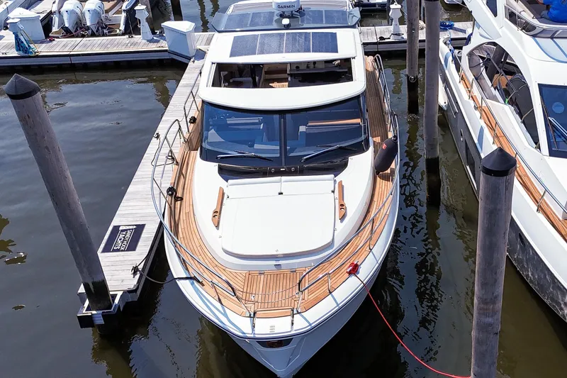 Slide: The Image of 2026 Marex 440 yacht docked at marina, showcasing sleek design and modern features. - 4