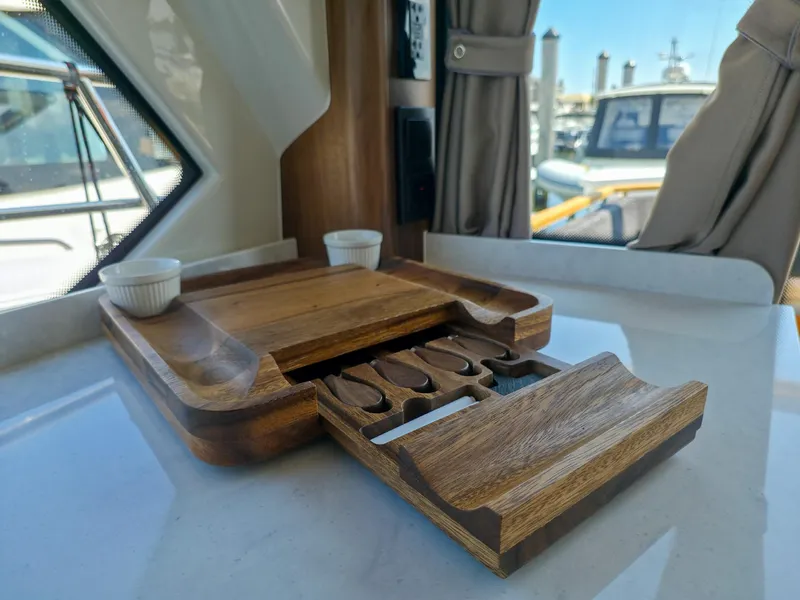 Slide: The Image of Interior of 2026 Marex 440 yacht with wooden tray and storage compartments. - 40
