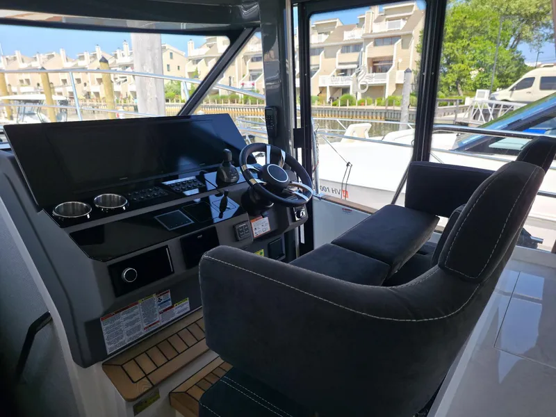 Slide: The Image of Helm of 2026 Marex 440 yacht with modern controls and comfortable seating. - 49