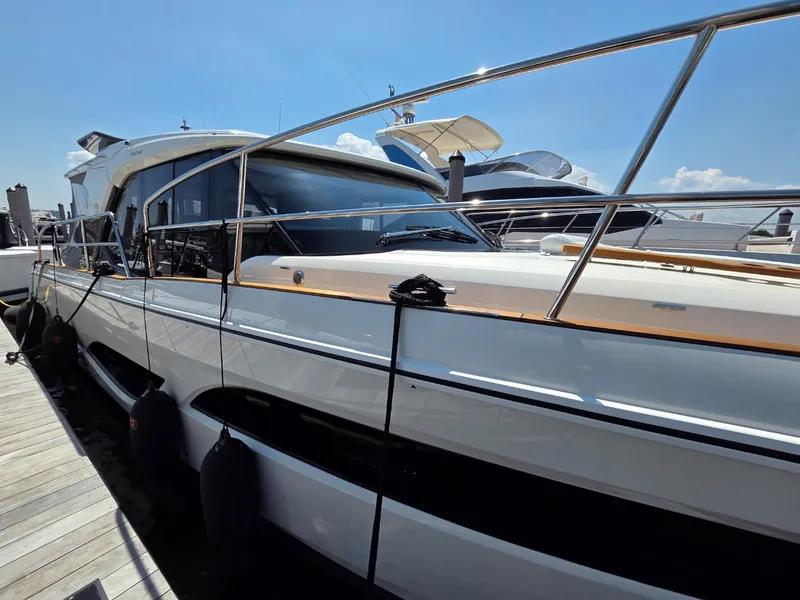 Slide: The Image of 2026 Marex 440 yacht docked, showcasing sleek design and modern features under a clear blue sky. - 7