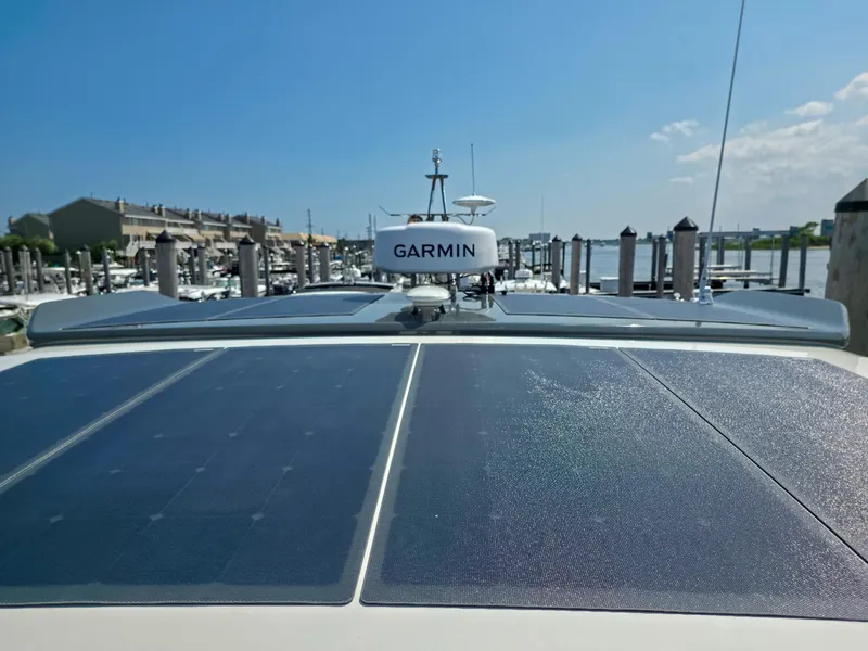 Slide: The Image of Marex 440 yacht with solar panels and Garmin equipment, docked at a marina, 2026 model. - 25