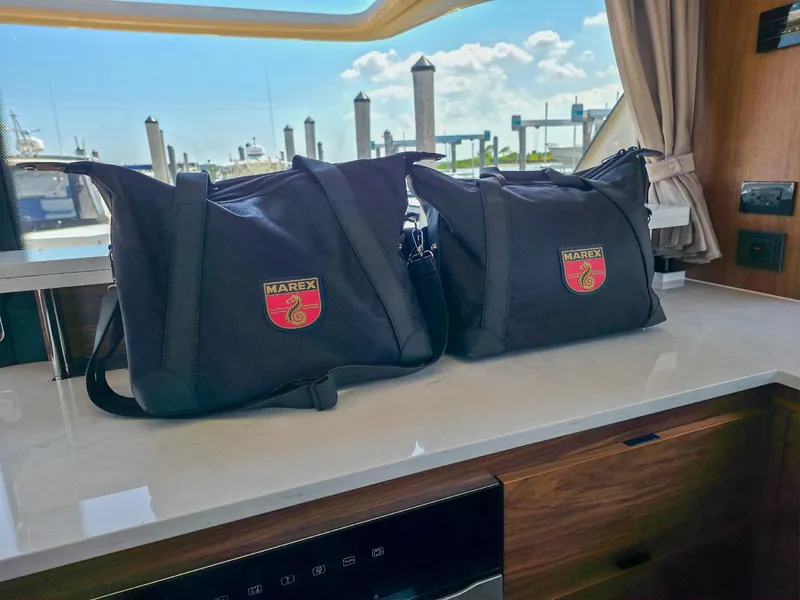 Slide: The Image of Two Marex-branded bags on a Marex 440 yacht's interior counter, 2026 model. - 30