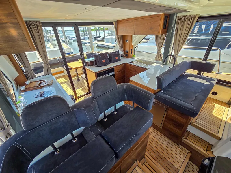 Slide: The Image of Luxurious interior of 2026 Marex 440 yacht with modern seating and wooden accents. - 50