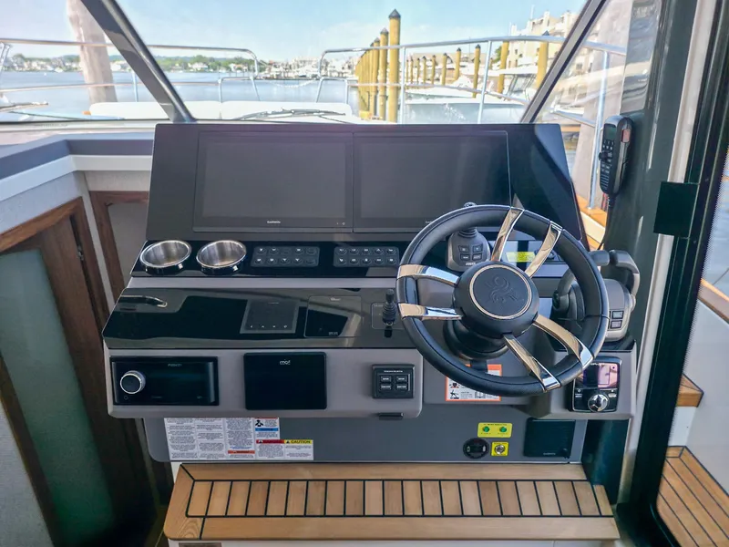 Slide: The Image of Helm of 2026 Marex 440 yacht with modern navigation controls and steering wheel. - 52