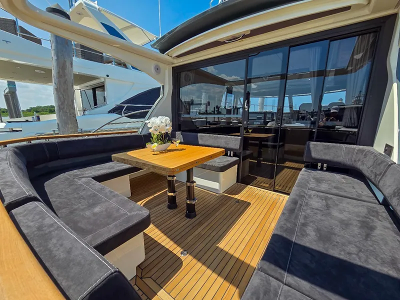 Slide: The Image of Luxurious 2026 Marex 440 yacht deck with elegant seating and wooden table. - 22