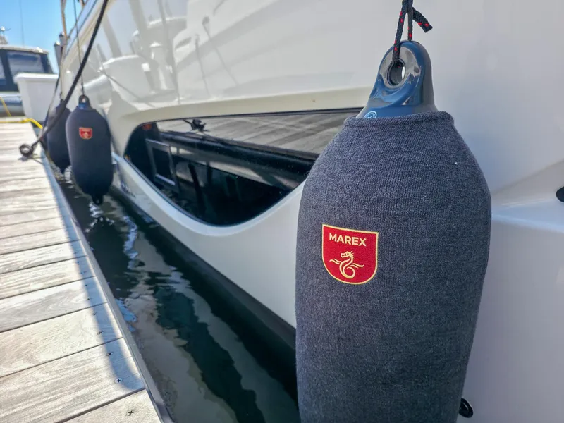 Slide: The Image of 2026 Marex 440 yacht docked with protective fenders, showcasing brand logo. - 31