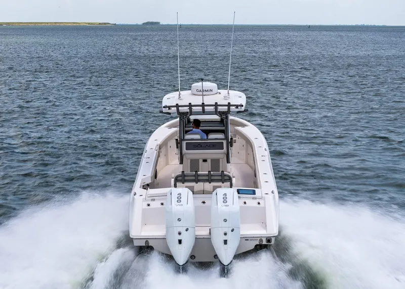 Slide: The Image of 2025 Solace 32 CS boat cruising on open water, rear view. - 10