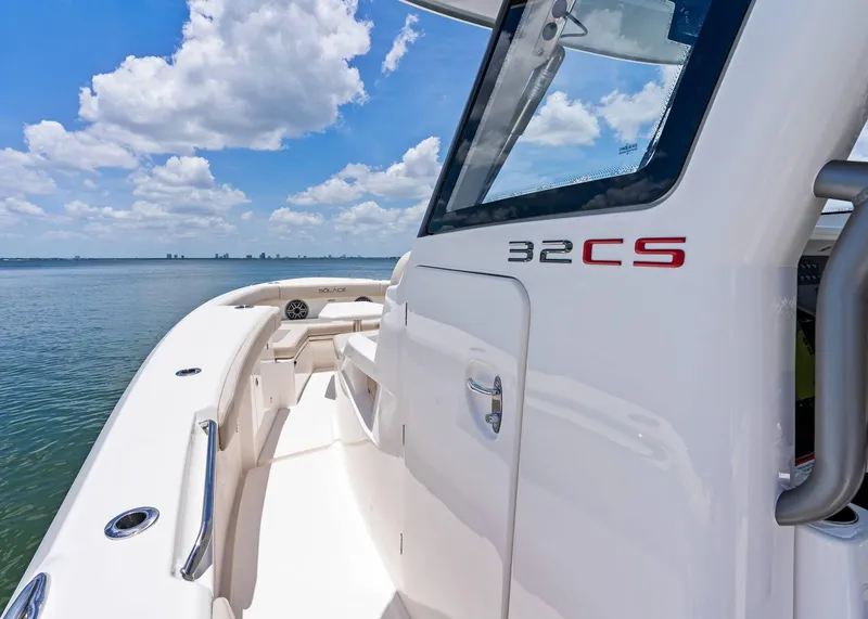 Slide: The Image of 2025 Solace 32 CS boat on calm water under a blue sky. - 18