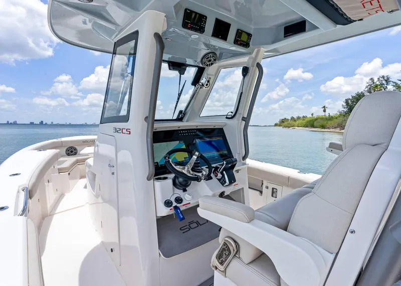 Slide: The Image of 2025 Solace 32 CS boat cockpit with modern controls and ocean view. - 20