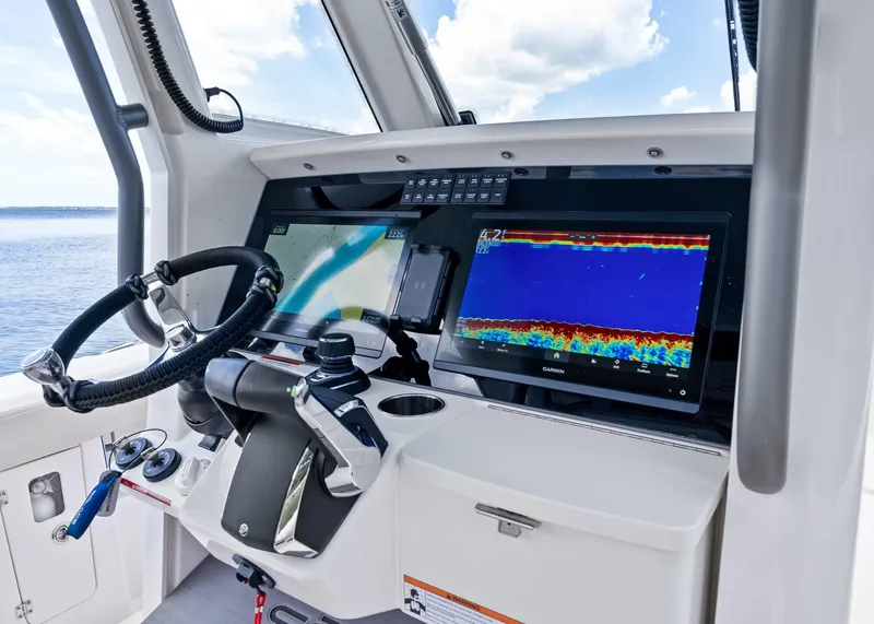 Slide: The Image of 2025 Solace 32 CS boat dashboard with advanced navigation and control systems. - 21