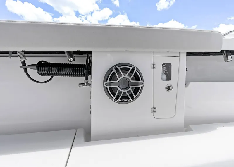 Slide: The Image of 2025 Solace 32 CS boat interior with speaker and storage compartment. - 23