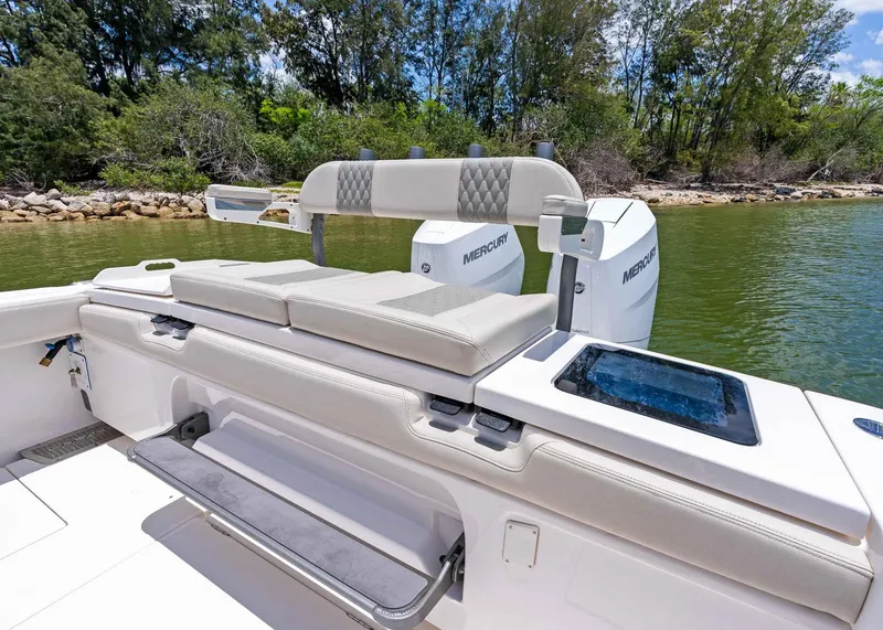 Slide: The Image of 2025 Solace 32 CS boat with Mercury engines, featuring comfortable seating and scenic water backdrop. - 28