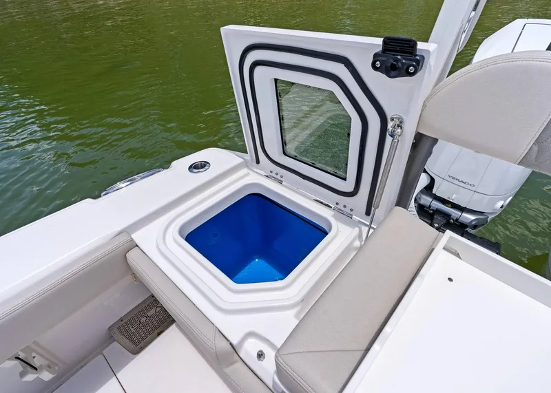 Slide: The Image of Open storage compartment on 2025 Solace 32 CS boat, featuring a blue interior. - 30