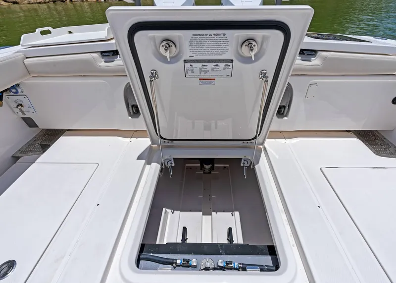 Slide: The Image of Open hatch on 2025 Solace 32 CS boat, revealing storage compartment. - 32