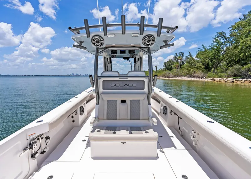 Slide: The Image of 2025 Solace 32 CS boat on calm water, featuring sleek design and modern amenities. - 33