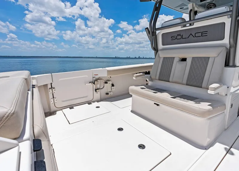 Slide: The Image of 2025 Solace 32 CS boat interior with seating, ocean view, and clear sky. - 35