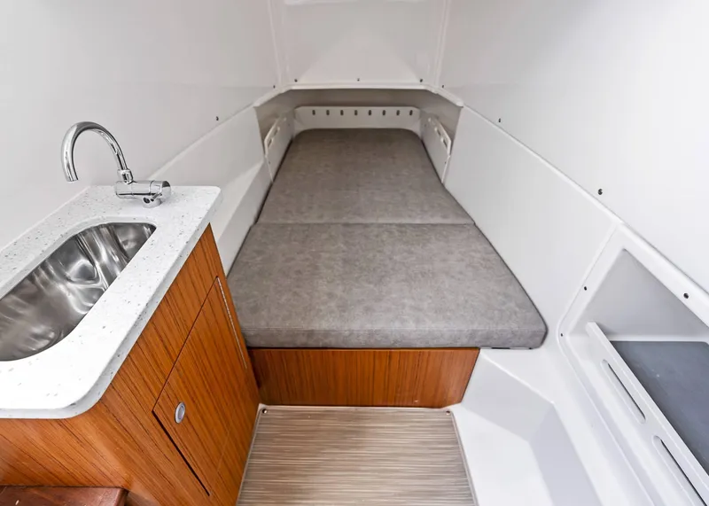 Slide: The Image of Interior of 2025 Solace 32 CS boat with bed and sink. - 38